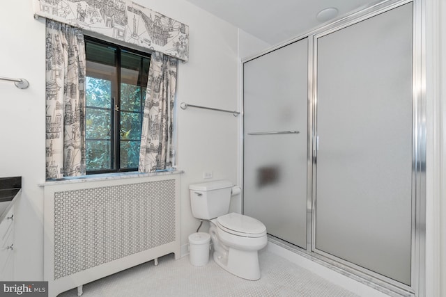 bathroom featuring radiator heating unit, tile patterned flooring, vanity, an enclosed shower, and toilet