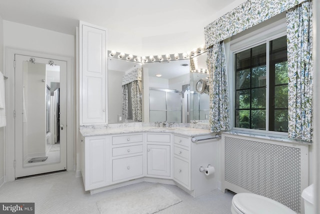 bathroom featuring walk in shower, tile patterned floors, vanity, and toilet