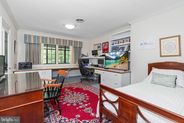 bedroom with ornamental molding and built in desk