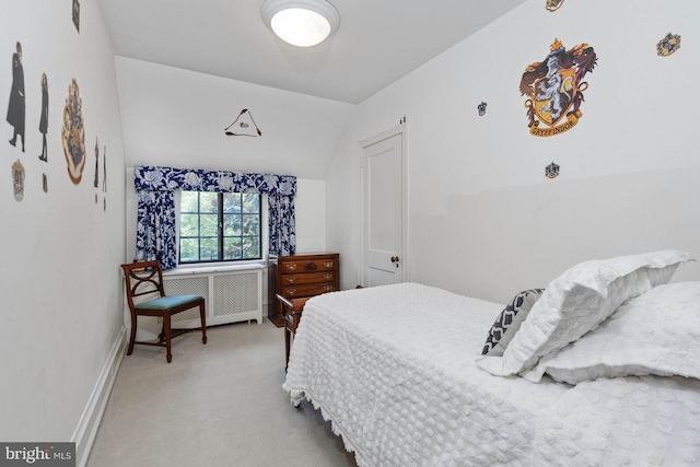 carpeted bedroom featuring vaulted ceiling and radiator