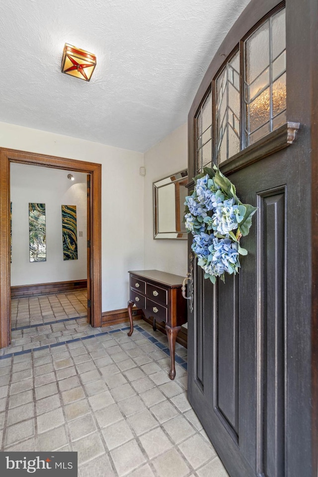 entryway with a textured ceiling