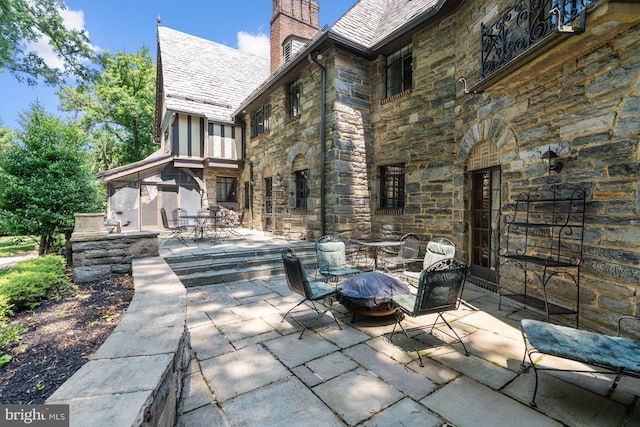 view of patio / terrace featuring an outdoor fire pit