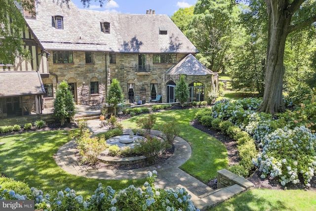 back of house featuring a yard and a patio area