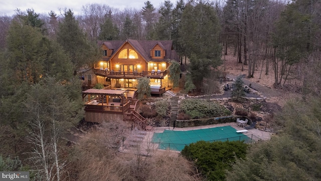 rear view of house featuring a swimming pool side deck