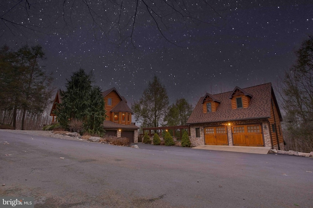 log home featuring a garage