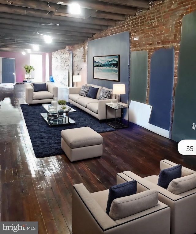 living room featuring brick wall, wood-type flooring, and beamed ceiling