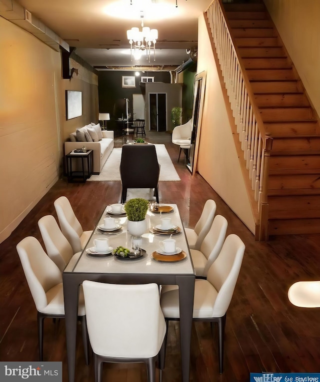 dining area with a notable chandelier and dark hardwood / wood-style flooring