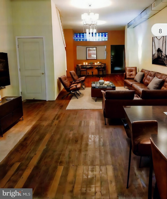 living room with a notable chandelier and hardwood / wood-style floors