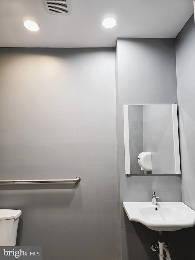 bathroom featuring sink and toilet