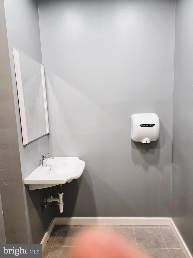 bathroom with sink and tile patterned flooring