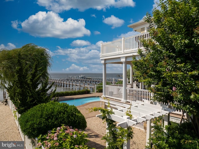 outdoor pool featuring a water view