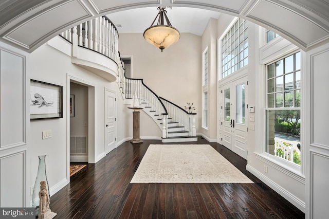 entrance foyer featuring dark wood-style floors, visible vents, and baseboards