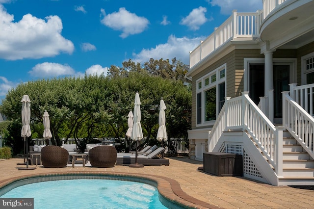 view of pool with a patio area, fence, outdoor lounge area, and a fenced in pool