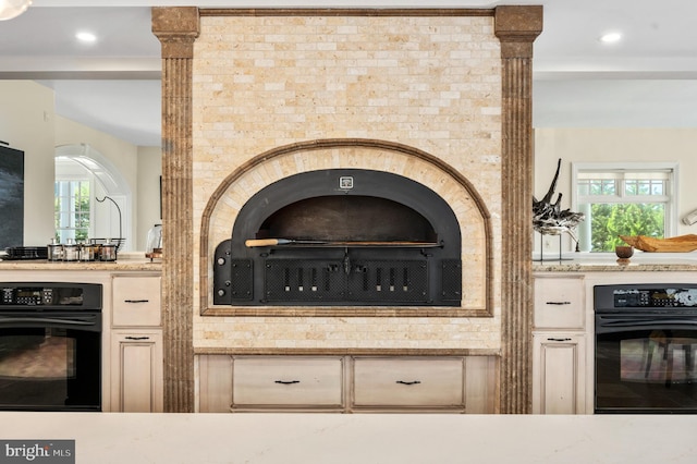 details featuring oven and light stone countertops