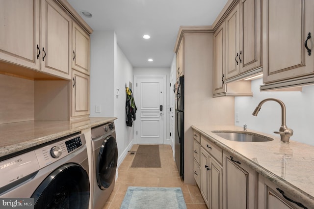 washroom with washing machine and dryer, baseboards, a sink, and recessed lighting