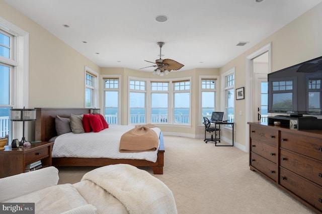 bedroom featuring light carpet, multiple windows, and visible vents