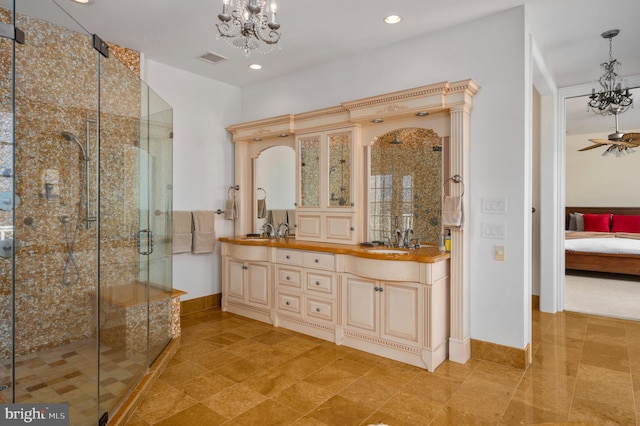 ensuite bathroom featuring a stall shower, visible vents, a sink, and ensuite bathroom