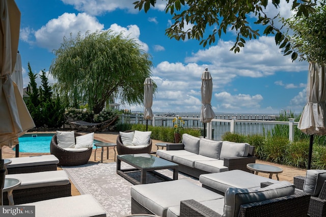 view of patio / terrace featuring outdoor lounge area and a water view