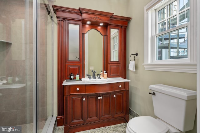 full bath featuring a stall shower, vanity, and toilet