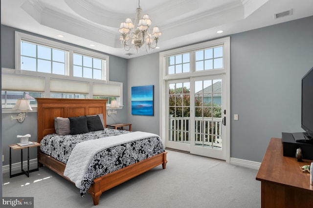 bedroom with access to exterior, a tray ceiling, visible vents, and light carpet