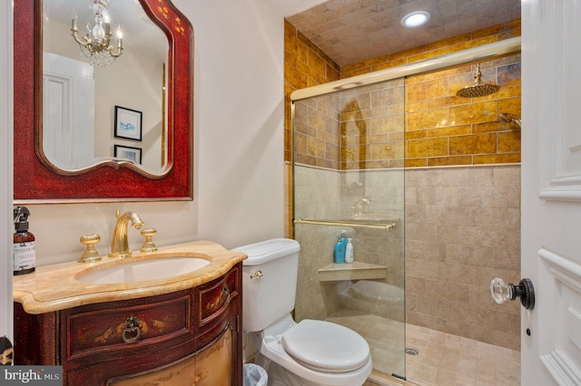 full bath with a shower stall, toilet, and vanity