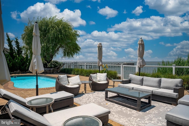 view of patio with a fenced in pool, a water view, fence, and an outdoor living space