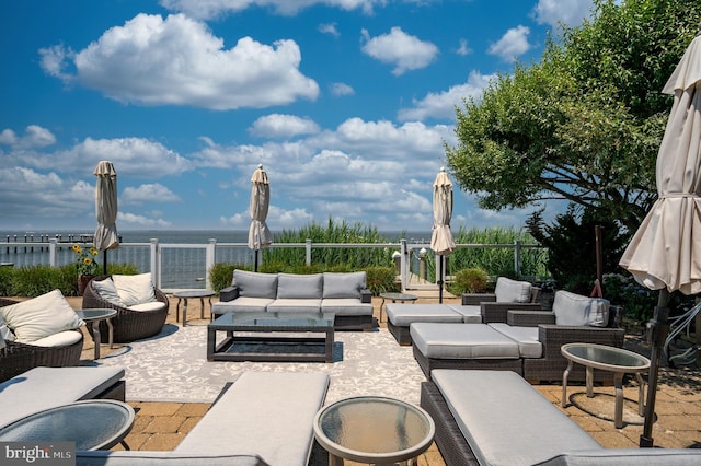 view of patio featuring outdoor lounge area and a water view