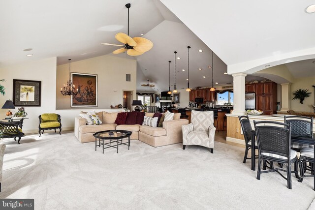 living room with lofted ceiling, light tile patterned flooring, ceiling fan, and plenty of natural light