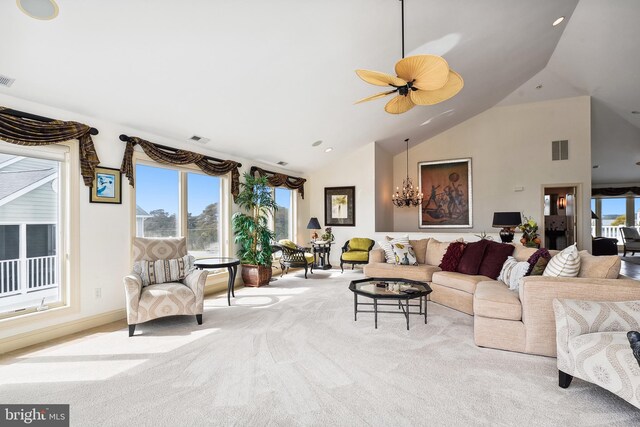 living room with decorative columns, light carpet, and plenty of natural light