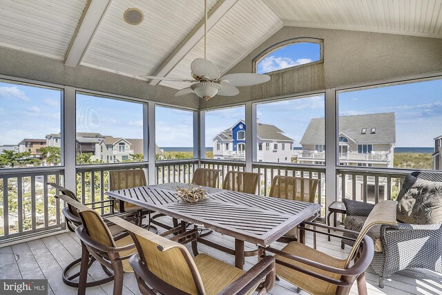 sunroom featuring ceiling fan and lofted ceiling with beams