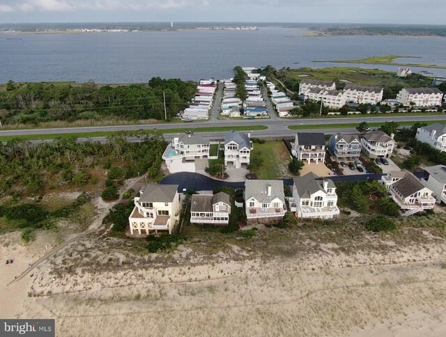 drone / aerial view with a water view and a beach view