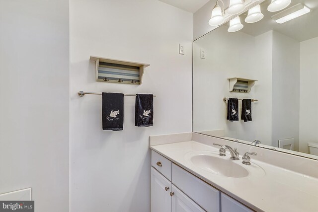 bathroom with toilet and vanity