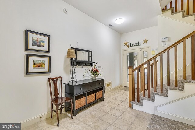 mudroom with concrete flooring and wood walls