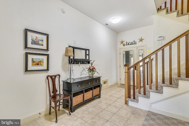 entrance foyer featuring visible vents, baseboards, and stairs