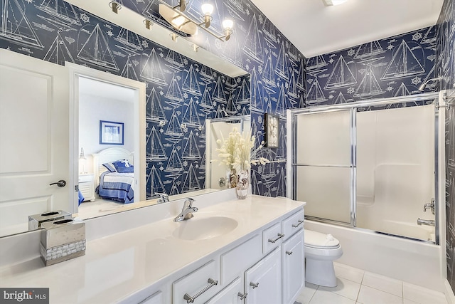 full bath featuring toilet, combined bath / shower with glass door, vanity, tile patterned flooring, and wallpapered walls