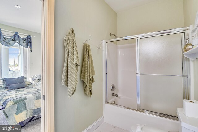 full bathroom featuring vanity, toilet, tile patterned floors, and bath / shower combo with glass door