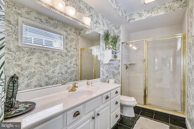 bathroom featuring tile patterned flooring, toilet, vanity, a stall shower, and wallpapered walls