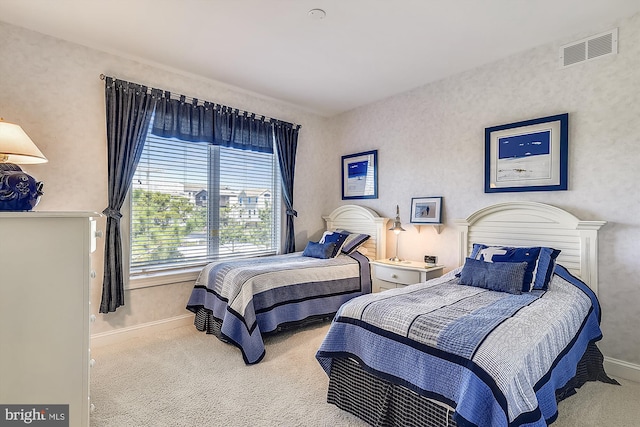 carpeted bedroom featuring visible vents and baseboards