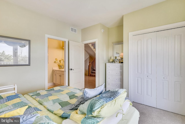 carpeted bedroom featuring a closet and visible vents