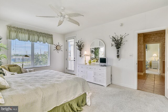 bedroom with access to outside and light colored carpet