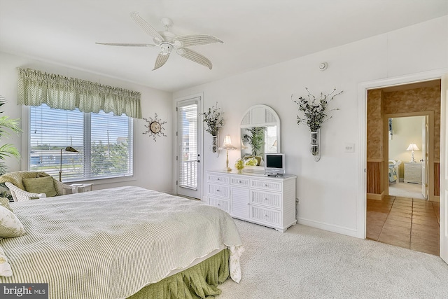 bedroom featuring access to exterior, light colored carpet, a ceiling fan, light tile patterned flooring, and baseboards