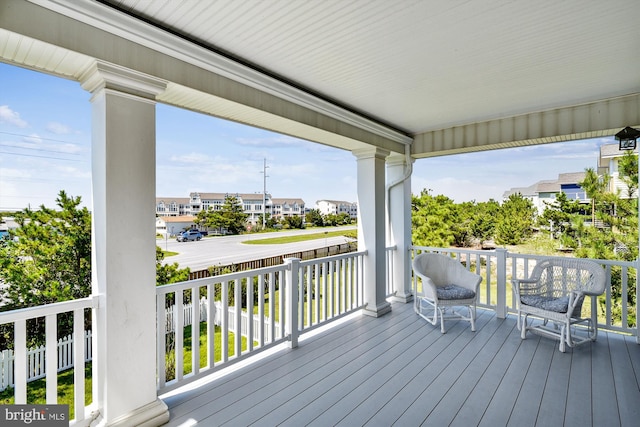 deck with covered porch and a residential view