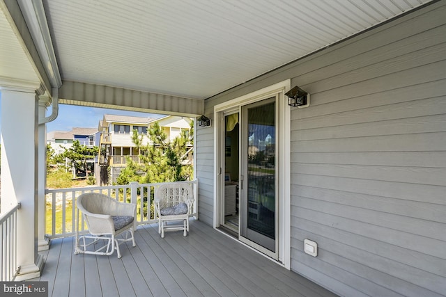 wooden terrace featuring covered porch