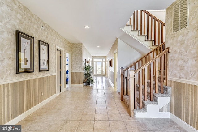 foyer with recessed lighting, visible vents, stairway, wainscoting, and wallpapered walls