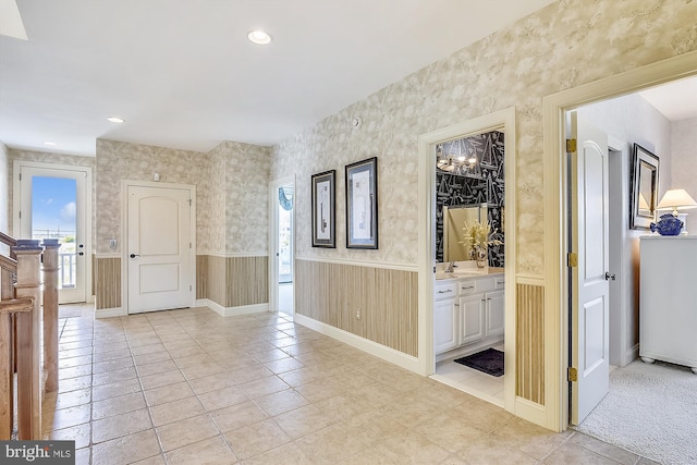 interior space with wallpapered walls, light tile patterned flooring, a wainscoted wall, and recessed lighting