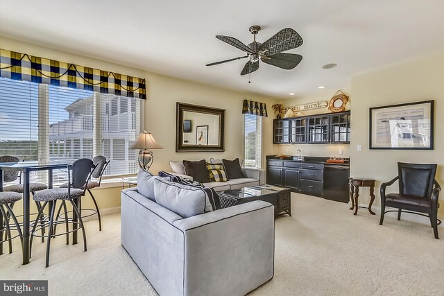 living room featuring light carpet and ceiling fan