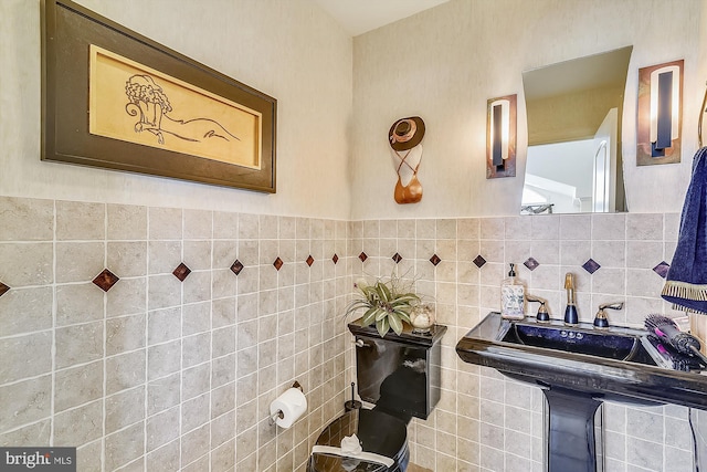 bathroom with tile walls