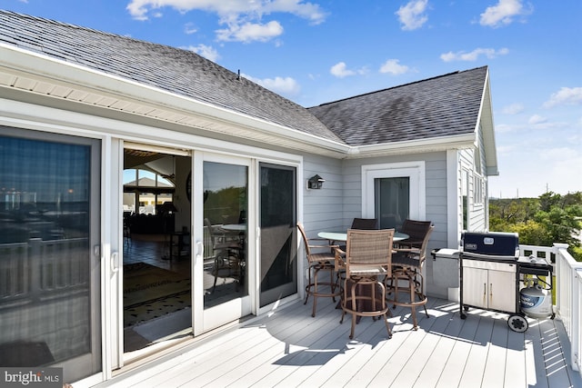 wooden terrace featuring outdoor dining area