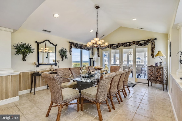 dining room featuring lofted ceiling, a wainscoted wall, visible vents, and an inviting chandelier