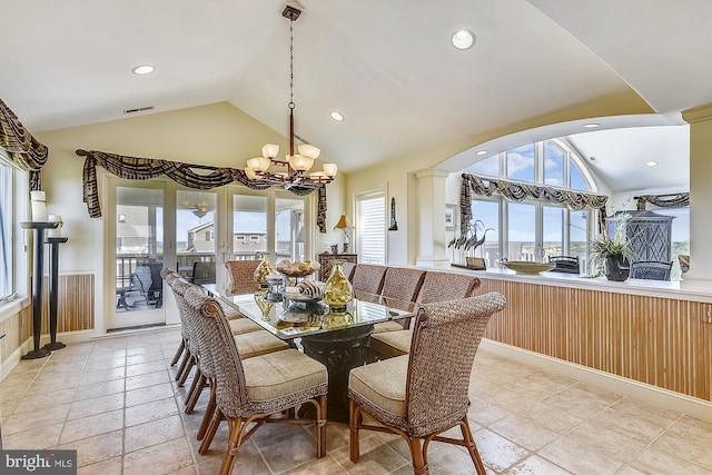 dining area featuring a healthy amount of sunlight, visible vents, vaulted ceiling, and a chandelier